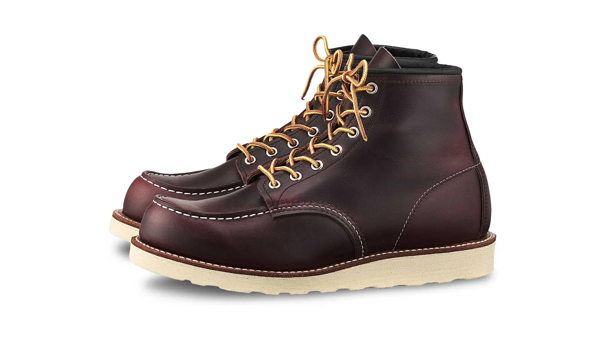 Dark oxblood leather moc toe boot with tan laces and a cream wedge sole