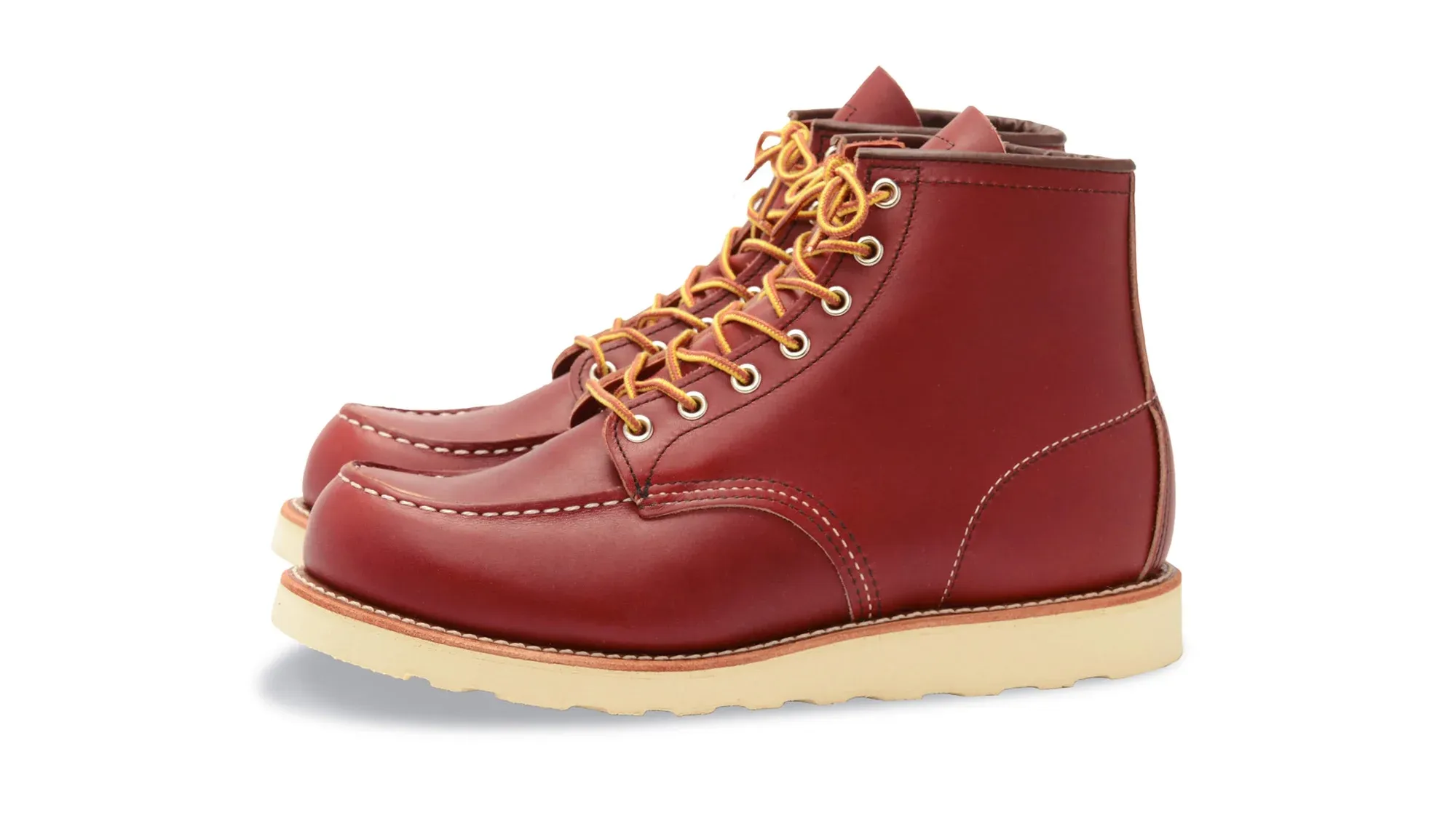 Red leather moc toe boot with yellow laces and a cream wedge sole