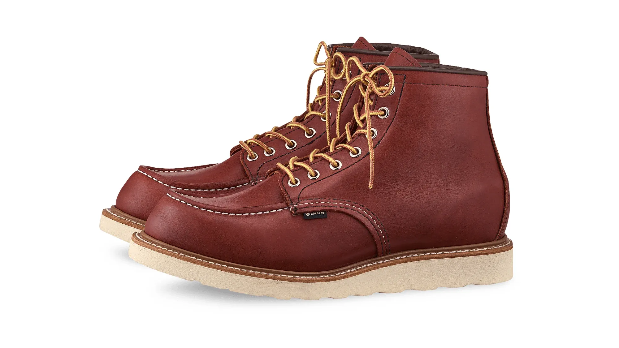 Russet brown leather moc toe boot with tan laces and a cream wedge sole