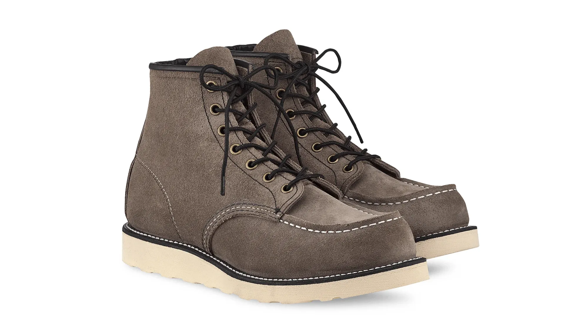 A pair of slate roughout suede moc toe boots on cream wedge soles, seen from the front at an angle