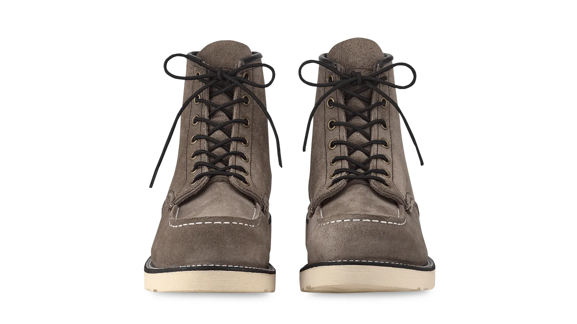 A pair of slate roughout suede moc toe boots on cream wedge soles, seen straight on from the front