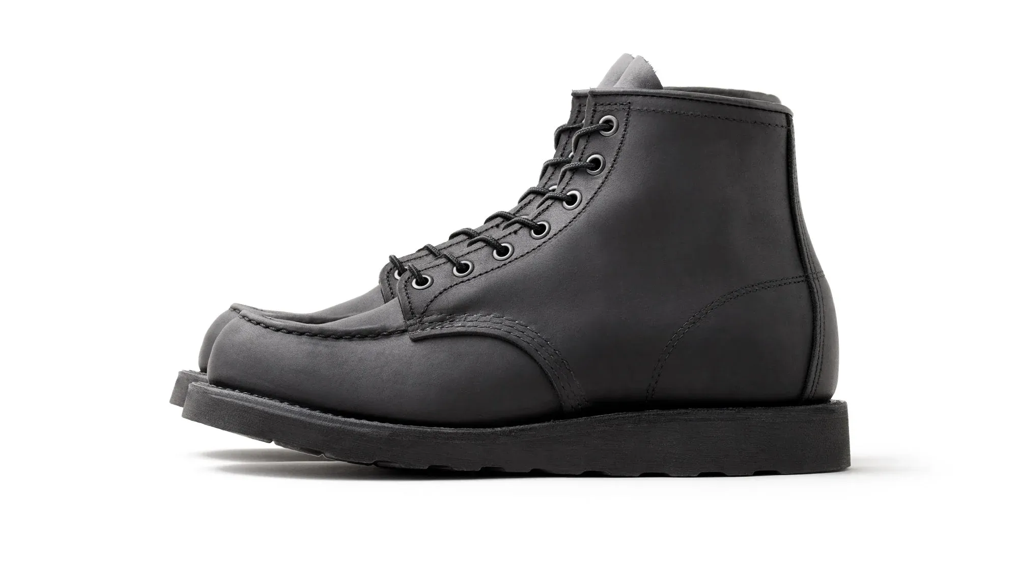 Black suede moc toe boot with black laces on a black lug sole