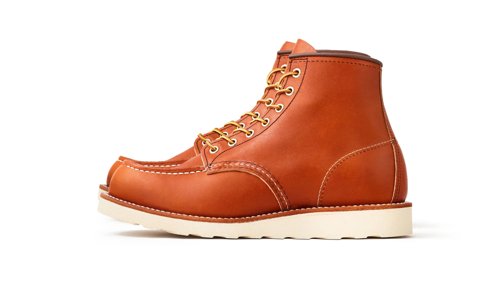 Amber orange leather moc toe boot with tan laces and a cream wedge sole