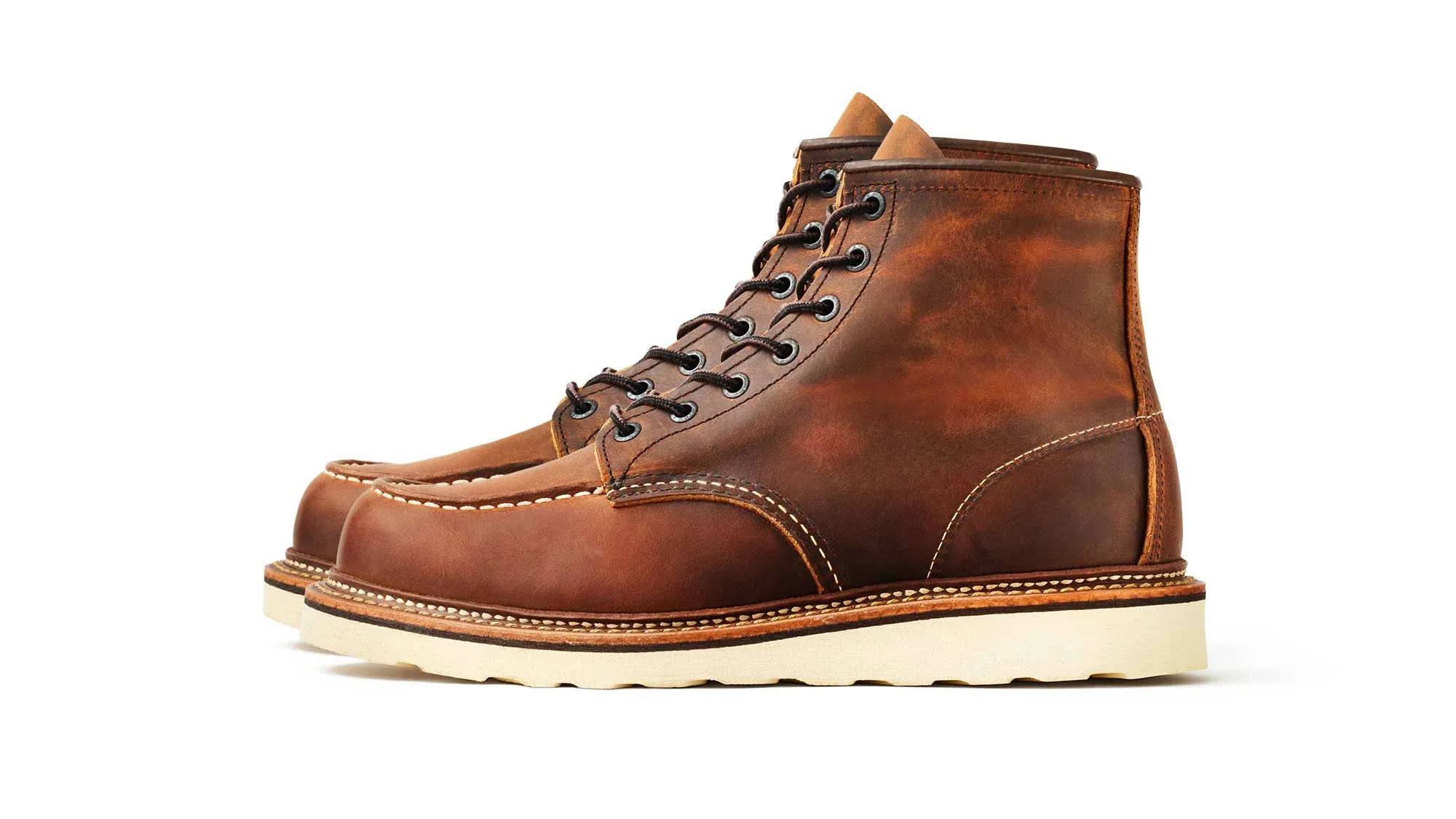 Copper brown leather moc toe boot with brown laces and a cream wedge sole