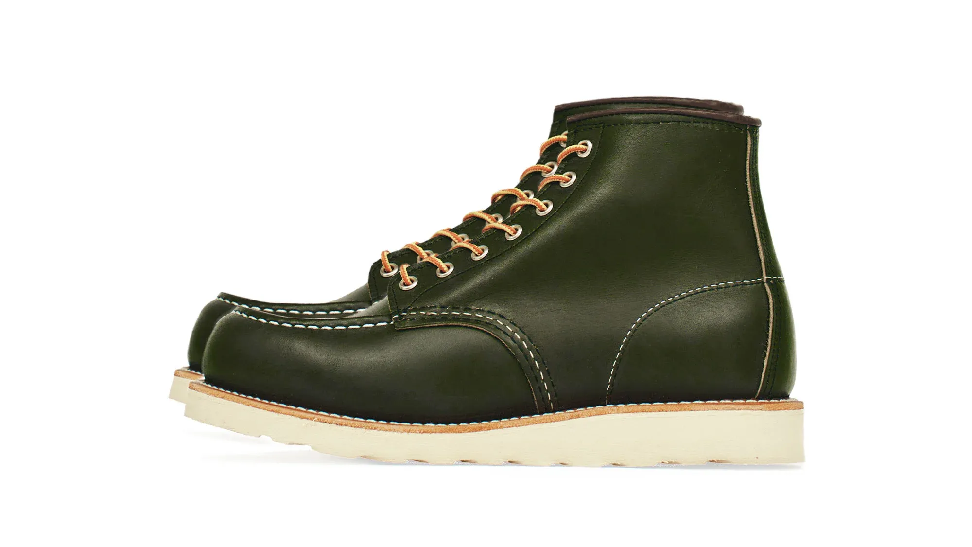 Forest green leather moc toe boot with tan laces and a cream wedge sole