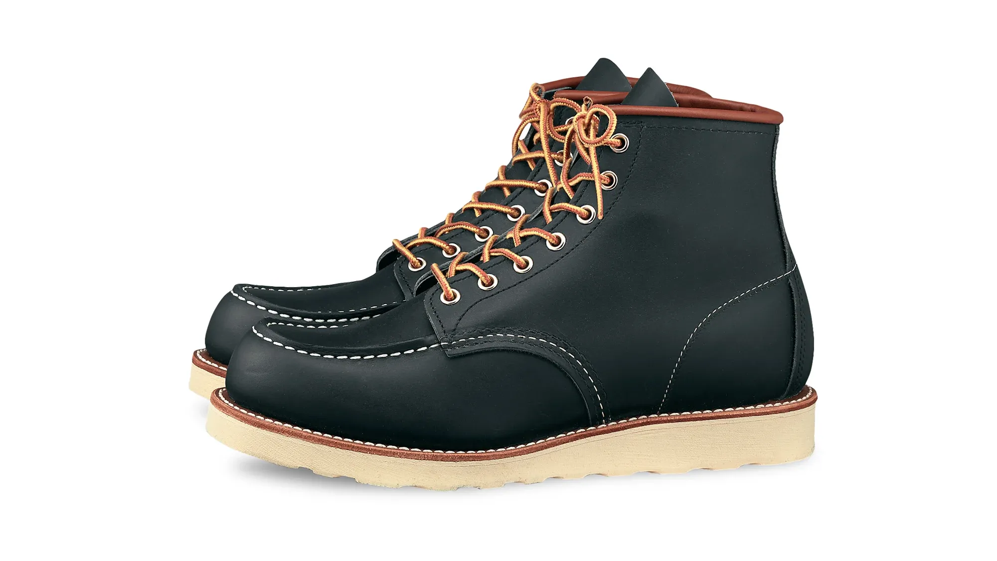 Navy leather moc toe boot with tan laces and a cream wedge sole